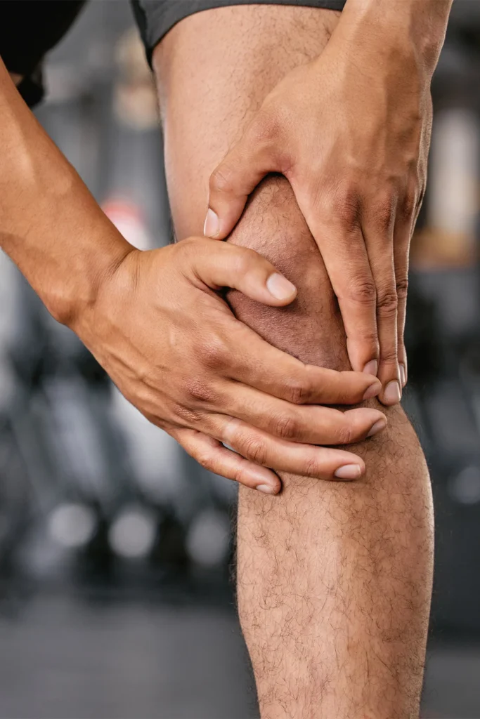 Close Up Man Holding His Knee In Pain