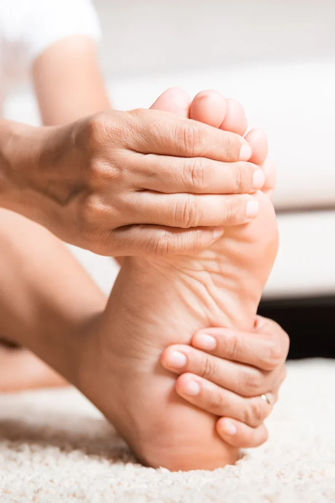 Person Holds Numb And Tingling Foot