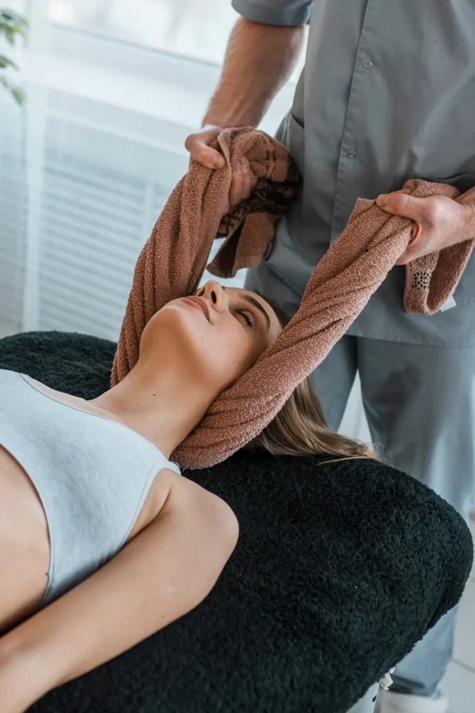 Woman Having Neck Stretched With Towel