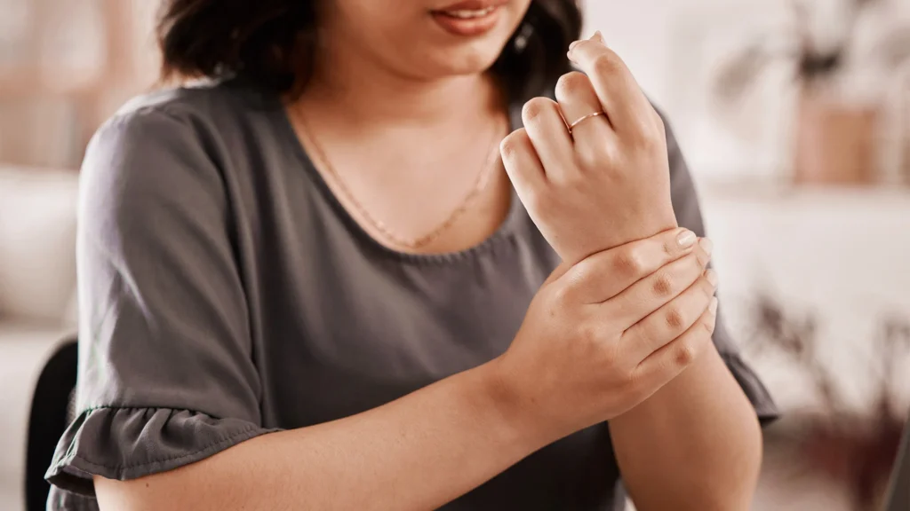 Woman Holds Her Tingling Wrist